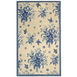 Hand hooked Flov Ivory/ Blue Wool Rug (29 X 49) (IvoryPattern FloralMeasures 0.375 inch thickTip We recommend the use of a non skid pad to keep the rug in place on smooth surfaces.All rug sizes are approximate. Due to the difference of monitor colors, s