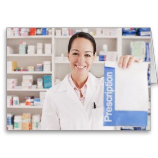 Pharmacist holding prescription in drug store greeting cards