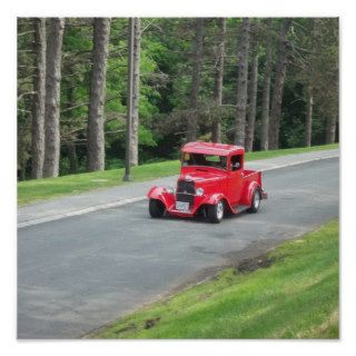 Classic red pickup truck rolling down the street poster