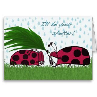 Ladybug sheltering the other with a leaf greeting cards