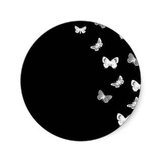 White Butterfies Against Black Round Sticker