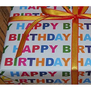 100% recycled birthday wrapping paper by green ribbon