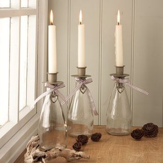 glass candle holder with hanging heart detail by the contemporary home
