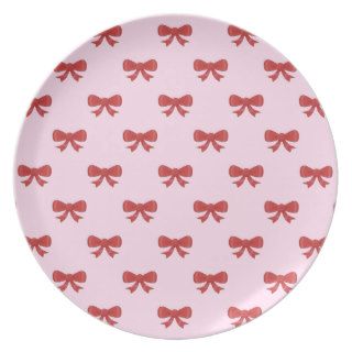 Pattern of nice red bows on pretty pink background plate