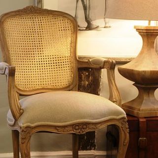 french style oak armchair by candle and blue