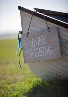 wooden 'gone fishing' sign by garden trading