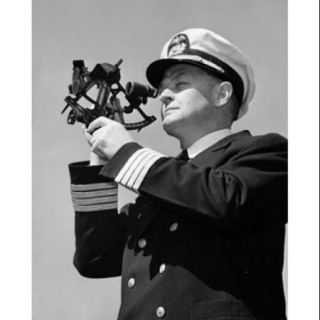 Low angle view of a ship captain looking through a sextant Poster Print (18 x 24)