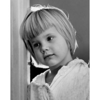 Little girl leaning against wall Poster Print (18 x 24)