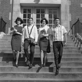 Four students on steps outside university Poster Print (18 x 24)